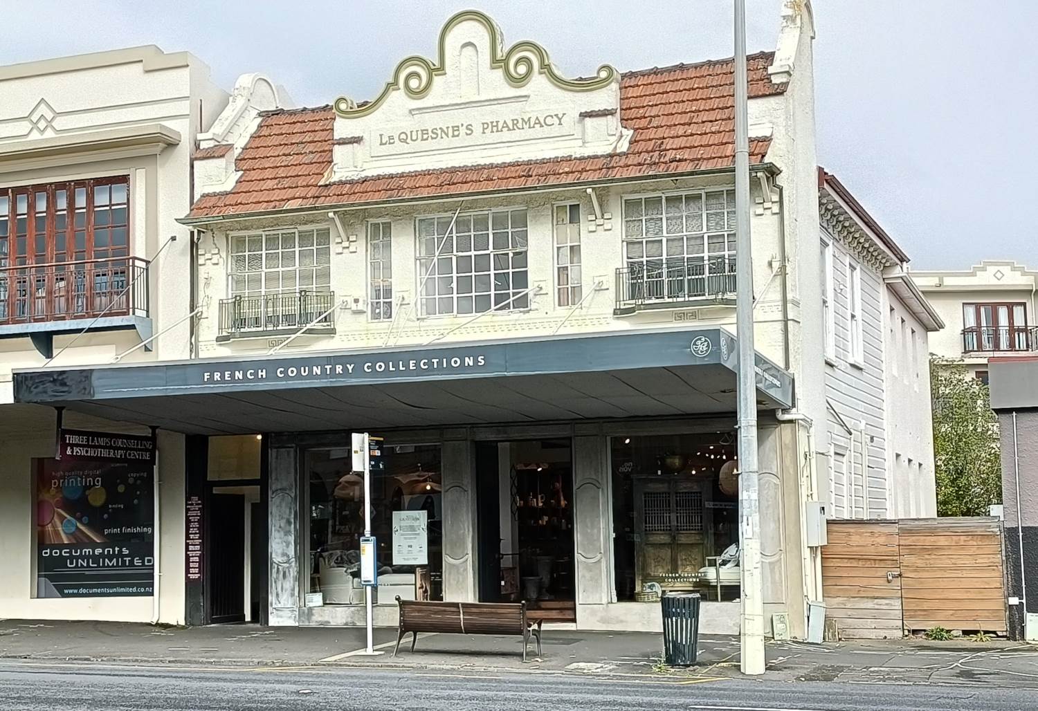 The white Le Quesne’s Pharmacy building at 2 Jervois Road, Ponsonby. Three Lamps is upstairs; the ground floor is a shop.